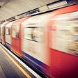 London Underground train blurred as it moves past platform