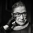 Black and White image of Ruth Bade Ginsburg wearing one of her signature collars