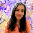 Selfie of Erin Singh; an Australian artist pictured with a digitally vibrant and colorful background abstract artwork of hers.