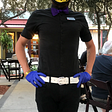 A young restaturant server with a blond mohawk and batman mask