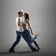 Man and a woman leaning on each other as they dance