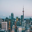 A cityscape photo of Toronto, with the CN Tower in the background