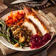 Photo of Thanksgiving dinner plate with delicious looking food.