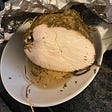 Turkey loaf cut in half on plate.