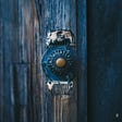 Image of an antique blue doorbell