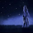 A woman standing in the blue of the night, talking to the stars, while stars twinkled around her body.