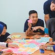 women and men at a table with post-it notes