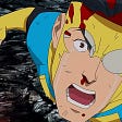 A close-up of Mark Grayson / Invincible wearing a blue and yellow super suit. The right side lens of his mask is shattered. He has a blood nose and there is blood on his forehead and knuckles. He is screaming and crying angrily.
