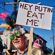 Parader holds sign at Krewe of Red Beans reading “Hey Putin Eat Me.” Photo by EPA.