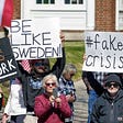 Group of protestors outside the Minnesota governors mansion, one holding a sign that says “Be Like Sweden”. Associated Press