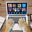 Parody image imagining how it would look to be a lion at work. The lion’s paws are typing on a laptop while attending a “zoo” conference online meeting. You can see images of different animals (like a horse, a cat, and a bison) on the “zoo” call.