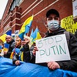 Ukraine citizen holding “Stop Putin” sign