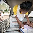 A pharmacy assistant in Mozambique reviews a vaccine delivery to a health center. Credit: Paul Joseph Brown