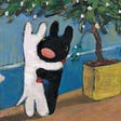 Two small dogs hug each other under a small potted tree