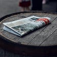 Newspaper on wooden barrel