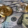 Bitcoins sit atop $100 US Dollar bills