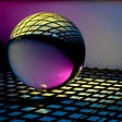 yellow and pink glass ball on blue and yellow checkered textile