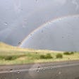 photo of a rainbow seen through a car window