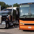Semi-Truck and Motorcoach side by side.