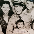 Isadore Greenbaum siting for the photo and wearing is petty officer uniform with is wife and three children, four years after the Nazi rally at the Madison Square Garden in New York.