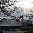 Half-mast American flag as respect for those dying from COVID-19.