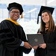 Interim Dean Anijo Mathew awarding a diploma to Monica Villazon San Martin