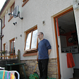 Brian Duff in summer 2003 standing outside the backdoor of a a semi-detached house in Edinburgh