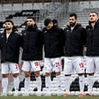 all the Iran players wore black jackets which covered up the national team badge.