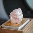 Picture of Rose Quartz on top of a deck of cards.