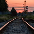 Photo of a railway track in dusk