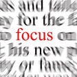 The word ‘focus’ sits in the middle of the image, the words around it on a page are blurred.