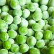 Image shows some frozen peas.