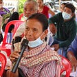 Cambodian woman participates in USAID public forum.