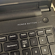 A snap of a laptop showing the power button. It shows how the power button is placed afar from the number pannel on the right, to avoid accidental clicks on the power button itself. Also, the power button is designed with a concave finish, making it accessibel even in low light, providing the user with a haptic feedback
