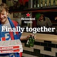 A still from Heineken’s ad of a football fan holding 2 pizza boxes and 2 Heineken beer bottles