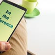A smart phone in the users hand, displaying the phrase ‘be the difference’