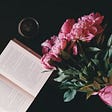 pink flower posy with open book and coffee