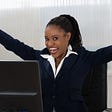 Woman cheering at her computer