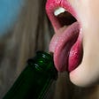 Woman licking beer bottle for cheating erotic short story