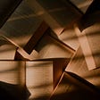 Books seen from above, brown books closeup photograph with shadow