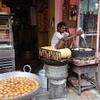 Man preparing food in a roadside shop in India