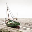 a boat stranded in mud on the thames estuary