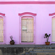 Three windows on a pink wall