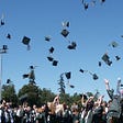 Graduation, hats being thrown.