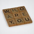 Scrabble tiles that spell the words Who Are You. Photo by Brett Jordan on Unsplash