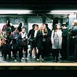 People waiting on an underground NYC subway platform for a train