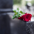 Red rose on a tombstone