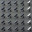 multiple CCTV cameras on a wall