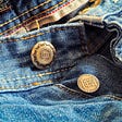 Close up view of blue jeans, unbuttoned