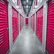inside the hall way of storage units with pink doors